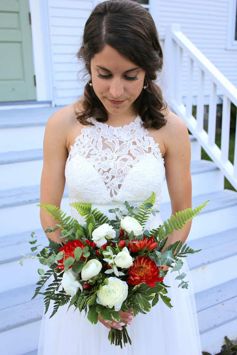 Bride staring down at bouquet | Acadia Wedding Photography