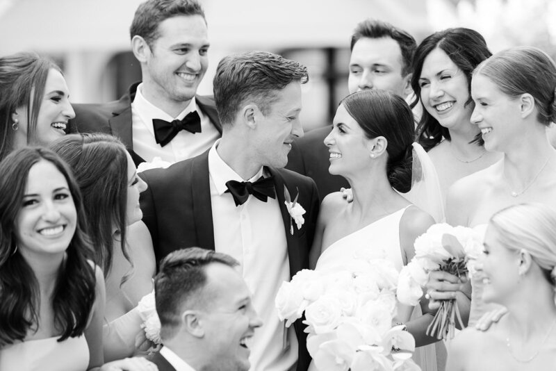 husband and wife with bridal party smiling on wedding day at the shoreby club in Ohio captured by The Cannons photography