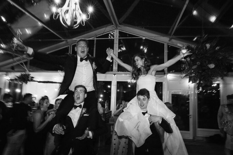 Couple dancing on Groomsmens shoulders at Acacia Ridge Winery