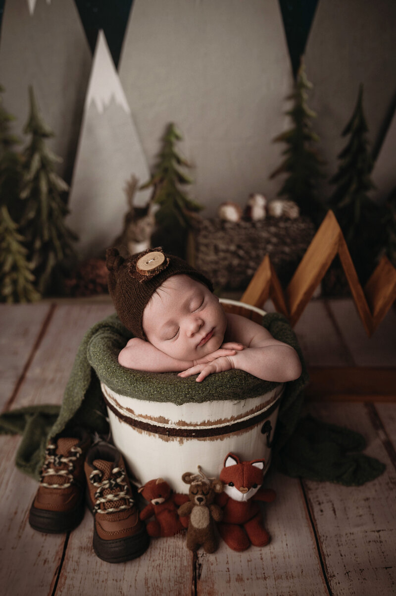 Stamford Newborn Studio Photographer captures newborn baby boy surrounded by hiking props