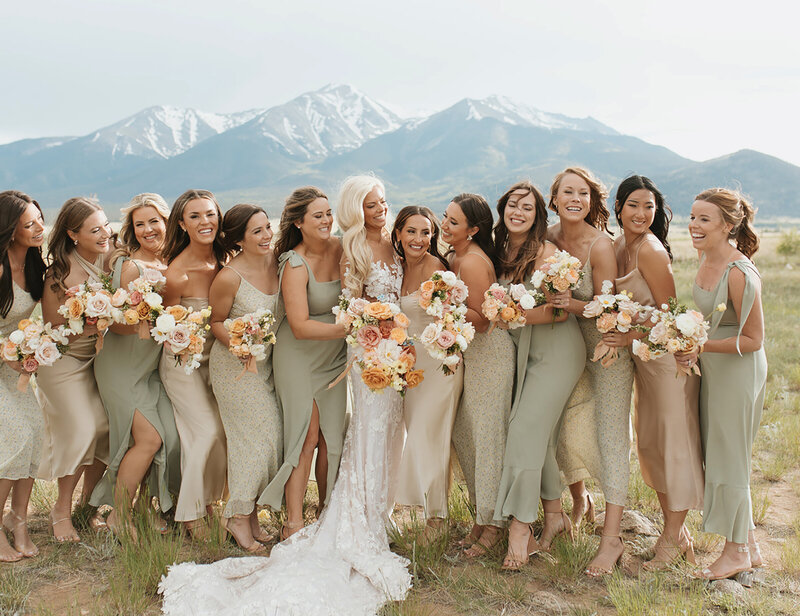 bride-with-bridesmaids-smiling-colorado-mountains