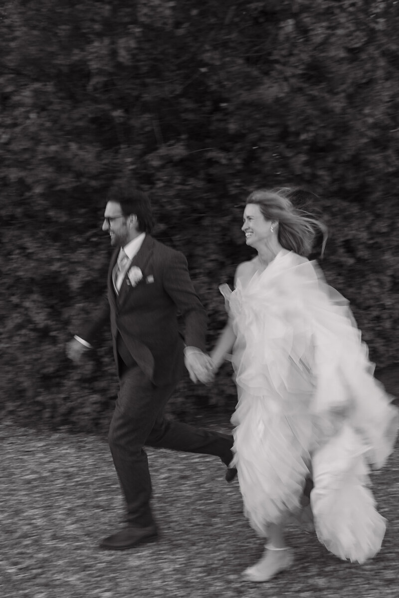 Wedding photographer captures couple taking a stroll hand in hand at their french chateau wedding.