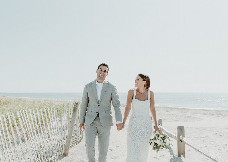 Bride and groom walking on beach at San Diego wedding