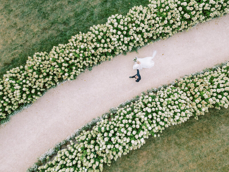 Drone photo of bride and groom on lush estate grounds – Multi-Day Wedding Photographer