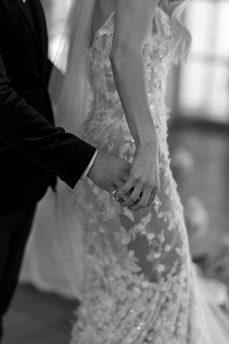 Medium range portrait of a bride and groom holding hands after their modern and intimate wedding in London city