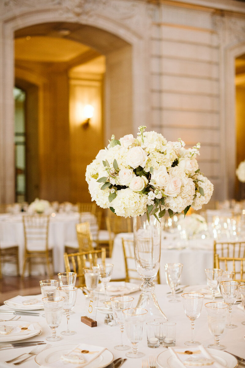 Tall wedding centerpiece with white roses and hydrangeas