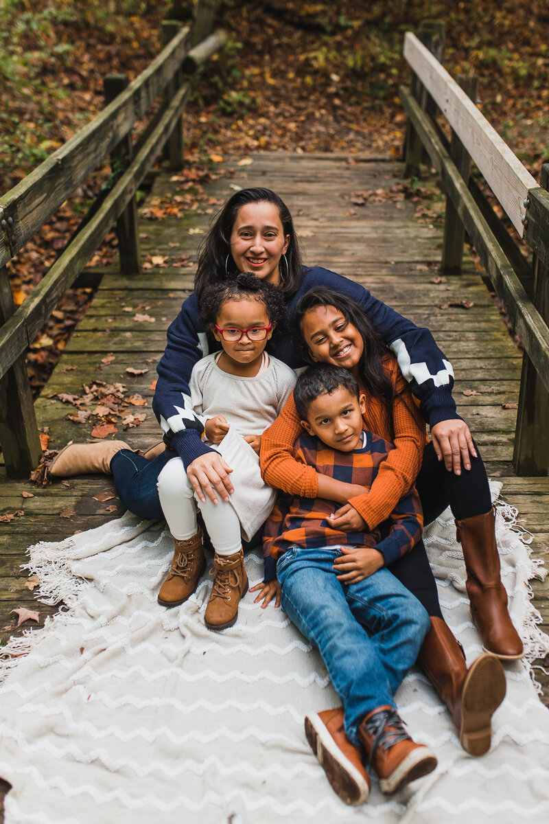 Family photographer capturing a mom and her three children.