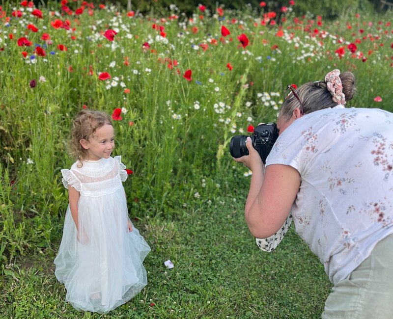 Wildflower magic—Denise captures a milestone moment surrounded by vibrant blooms.