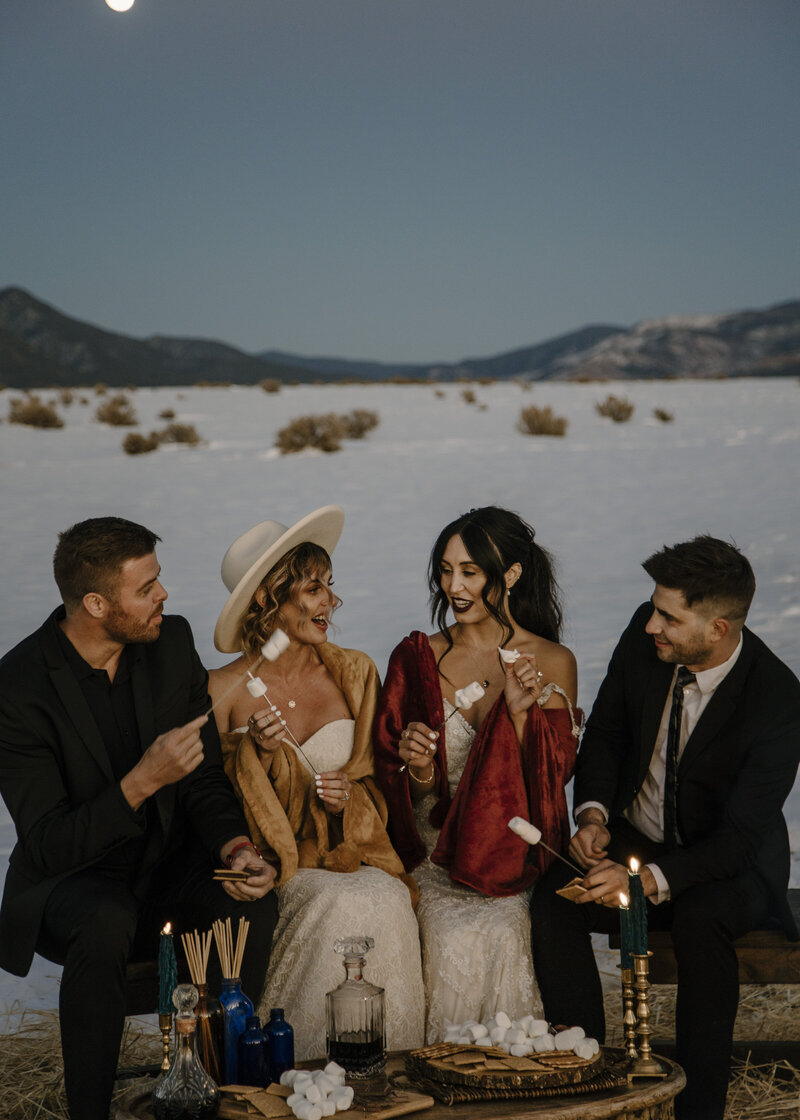 couples roasting smores around a campfire after eloping in colorado