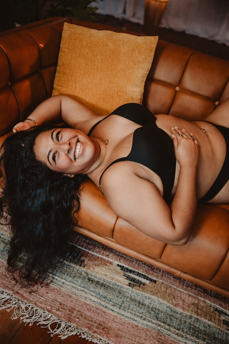 A person in lingerie laying on a couch 