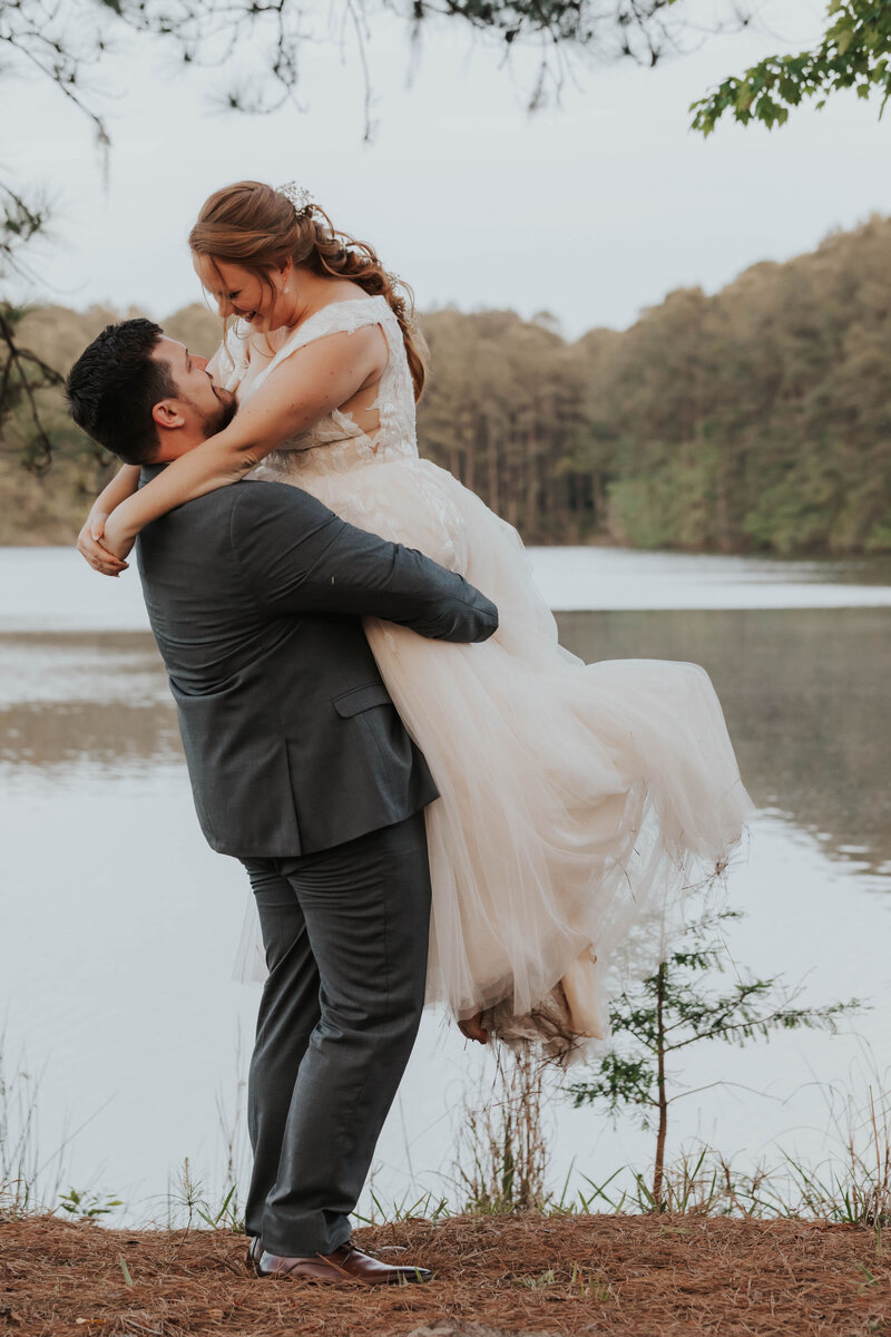 groom picking up bride