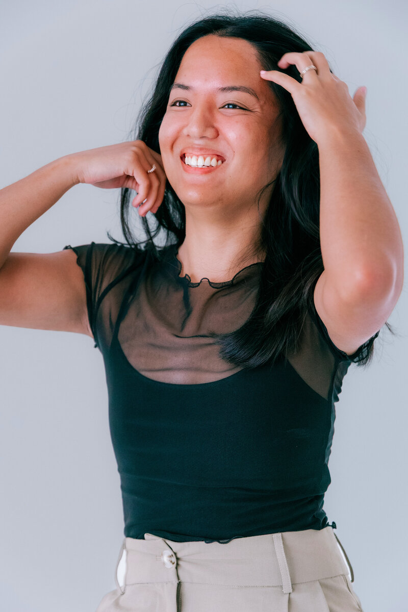 Emily laughing with coffee mug in hand while designing website in jacksonville fl