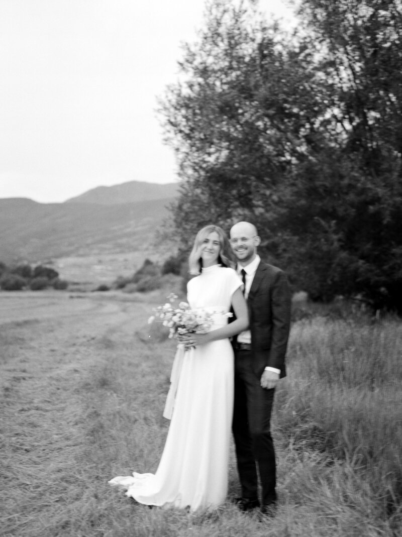 Bride and Groom in field laughing