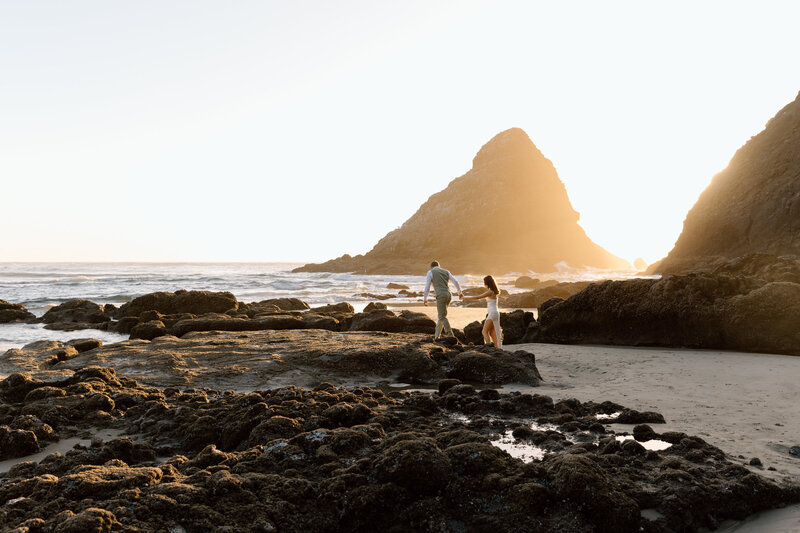 Bride and groom sitting on a bench in the Akron Art Museum with a gallery of paintings behind them. 