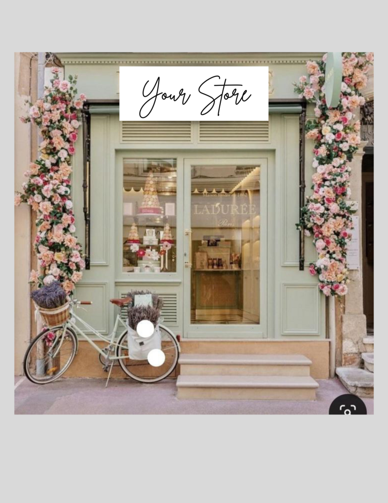 light green store front with floral pillars on each side of the door and a bicycle