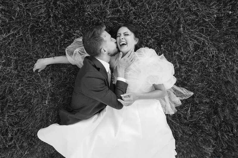 couple laying in the grass laughing
