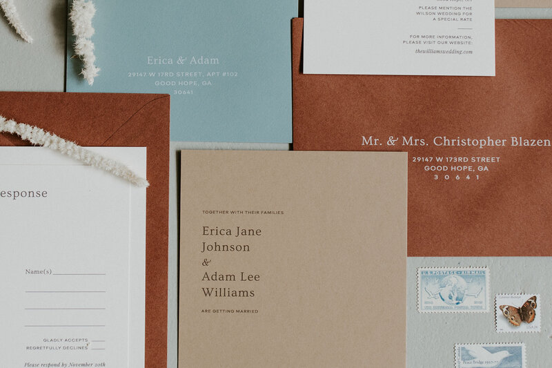Modern brown wedding invitation with orange and blue envelopes