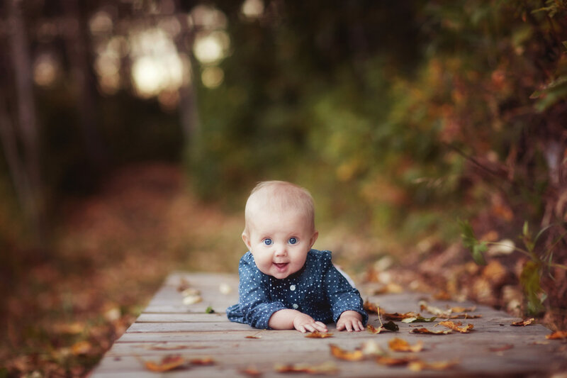 baby smiling in photo on bridge