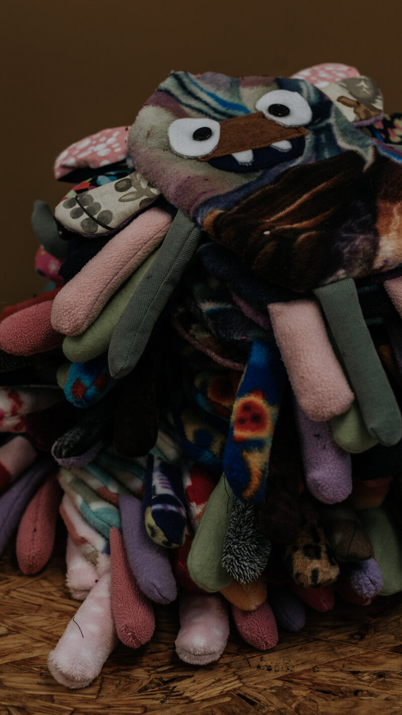 unique stuffed animal on pile of fabric