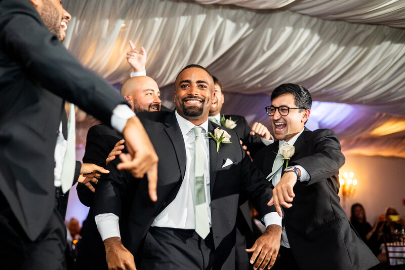 Groomsman enter reception tent with dancing and fun, Baltimore Wedding Photographer Kimberly Dean