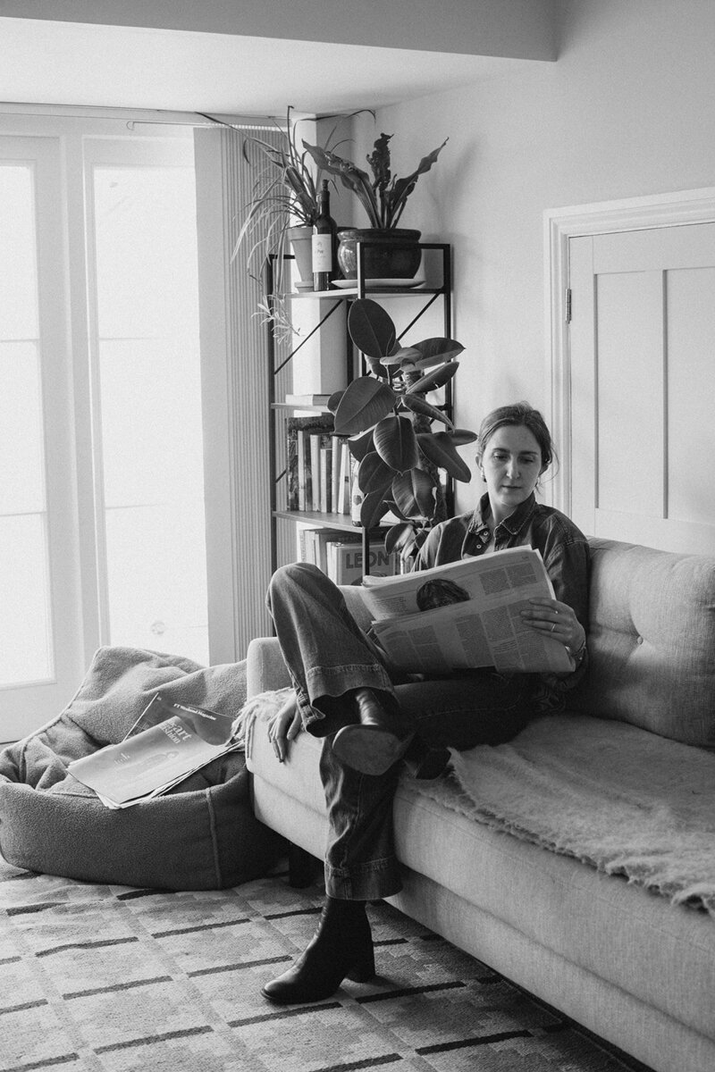 Business coach and copywriter reads the financial times at home in oxfordshire