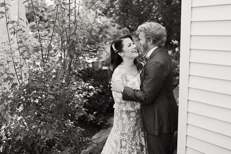 Husband and wife look at each other in backyard St. Louis wedding