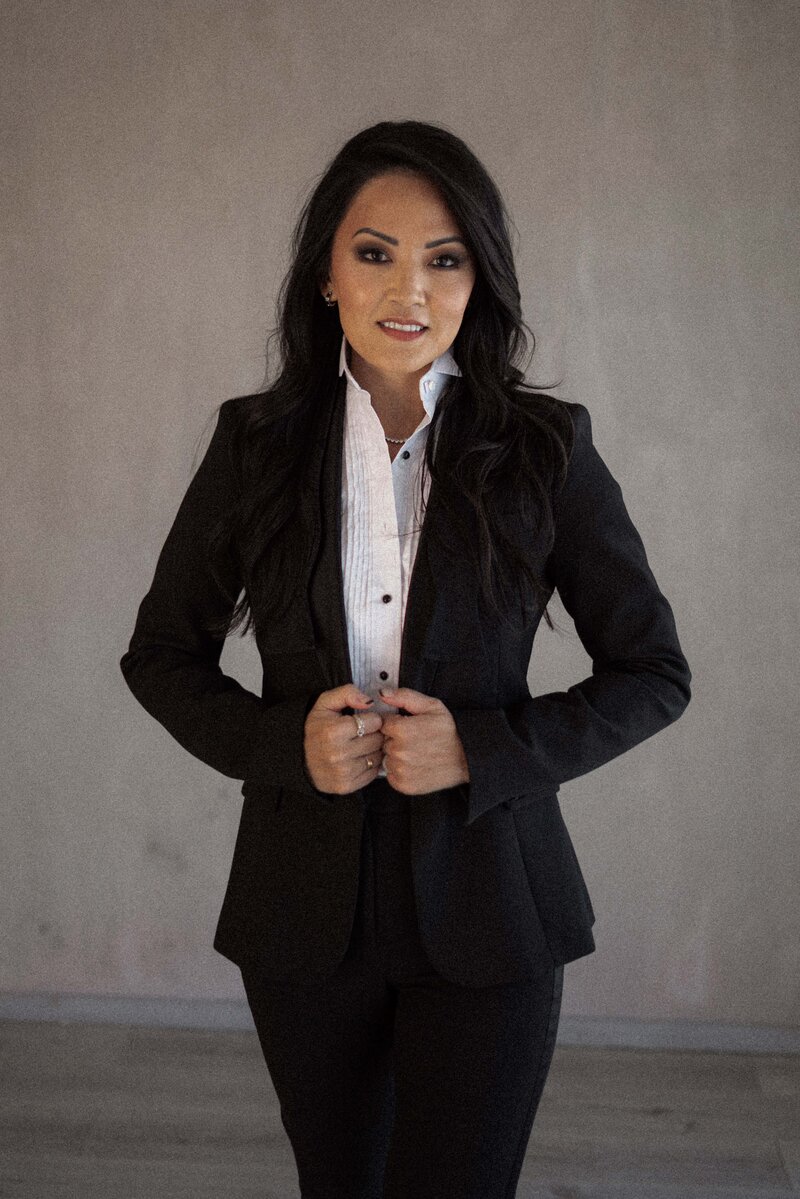 Sandy Chang in black suit and white shirt, embodying modern brand strategy and confidence for creative entrepreneurs.