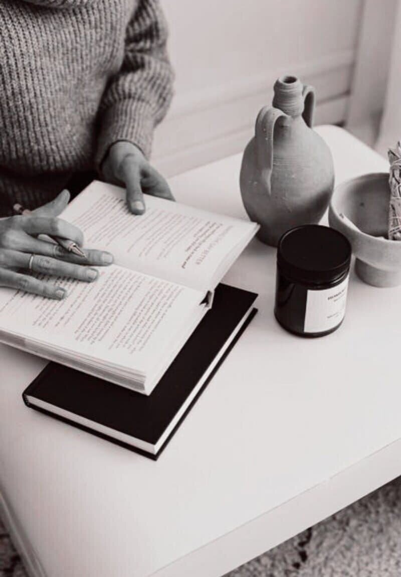 Woman writing in a book, representing uncovering the real story behind a brand to engage and connect audiences.