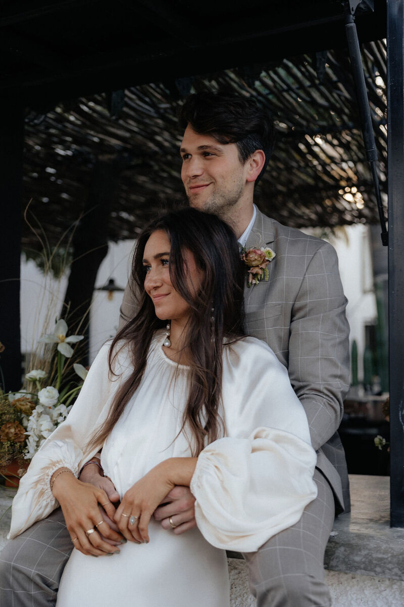 Bride and groom watching wedding speeches