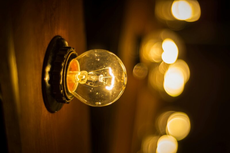 Industrial vintage lightbulb glowing warmly, symbolizing bright ideas, attention to detail, and expert copy editing and proofreading services.