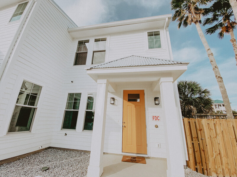 white townhome with orange door