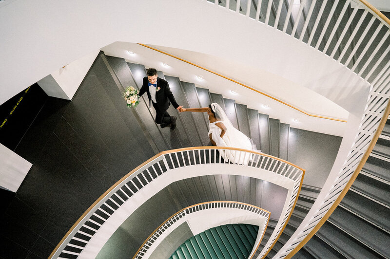 bride and groom on staircase of the museum of contemporary art chicago
