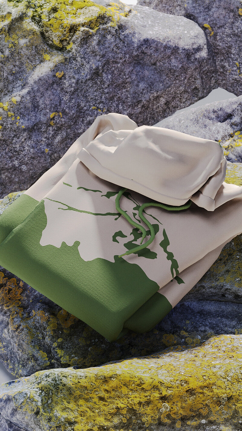Folded Alpath hoodie with abstract mountain contour print in earthy green tones, styled atop rugged alpine rocks—symbolizing the brand’s spirit of adventure and connection to nature.