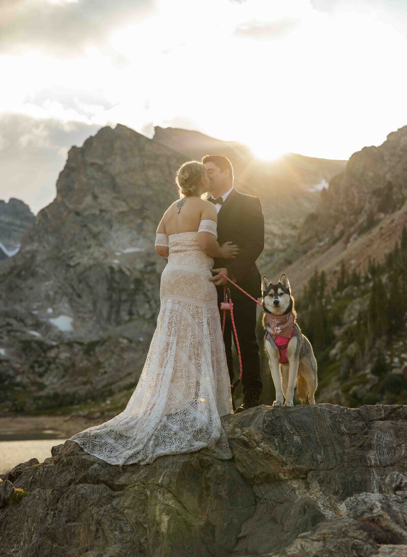 A couple eloping with their dog in Colorado at Lake Isabelle trailhead with a mountain view and epic sunset pictures with photography