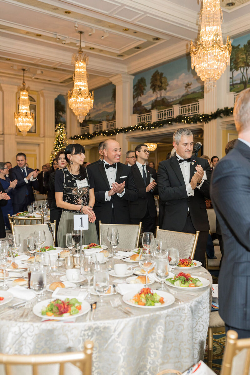 Dinner gala attendees clap for presentation