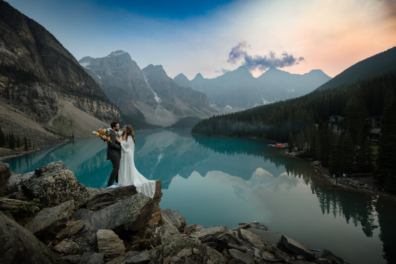 Couple sharing a tender moment at a viewpoint in Canmore on their wedding day