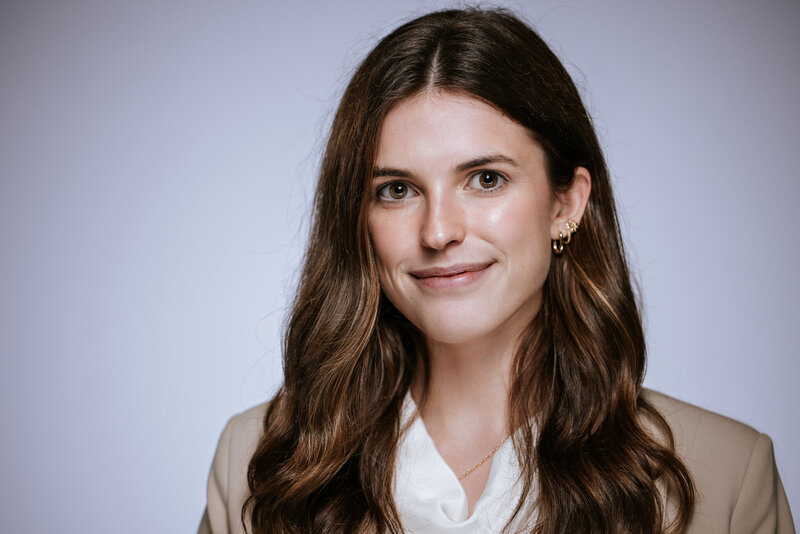 Confident young woman in business attire posing for a professional headshot with soft lighting, photographed in Houston by Giovanni Logrono

