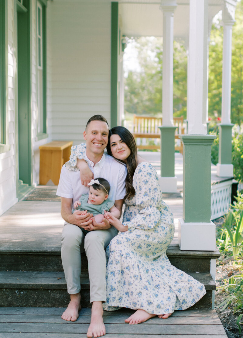photos of family at their home holding baby
