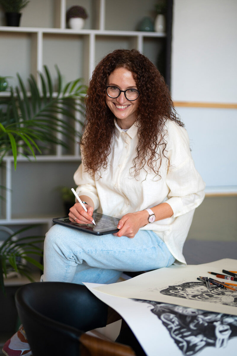 Woman leaning in the table while doing her art