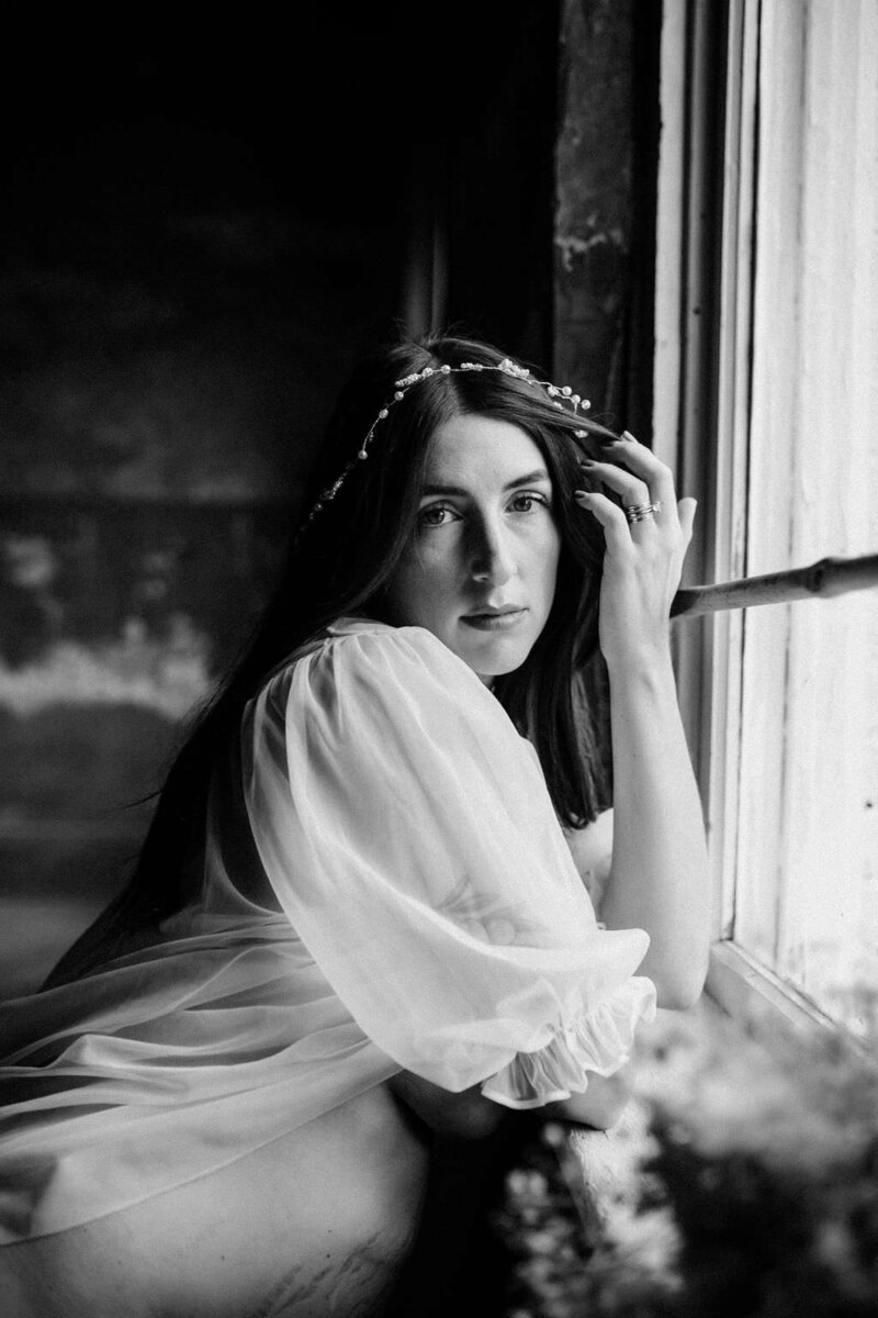 black and white image woman by window