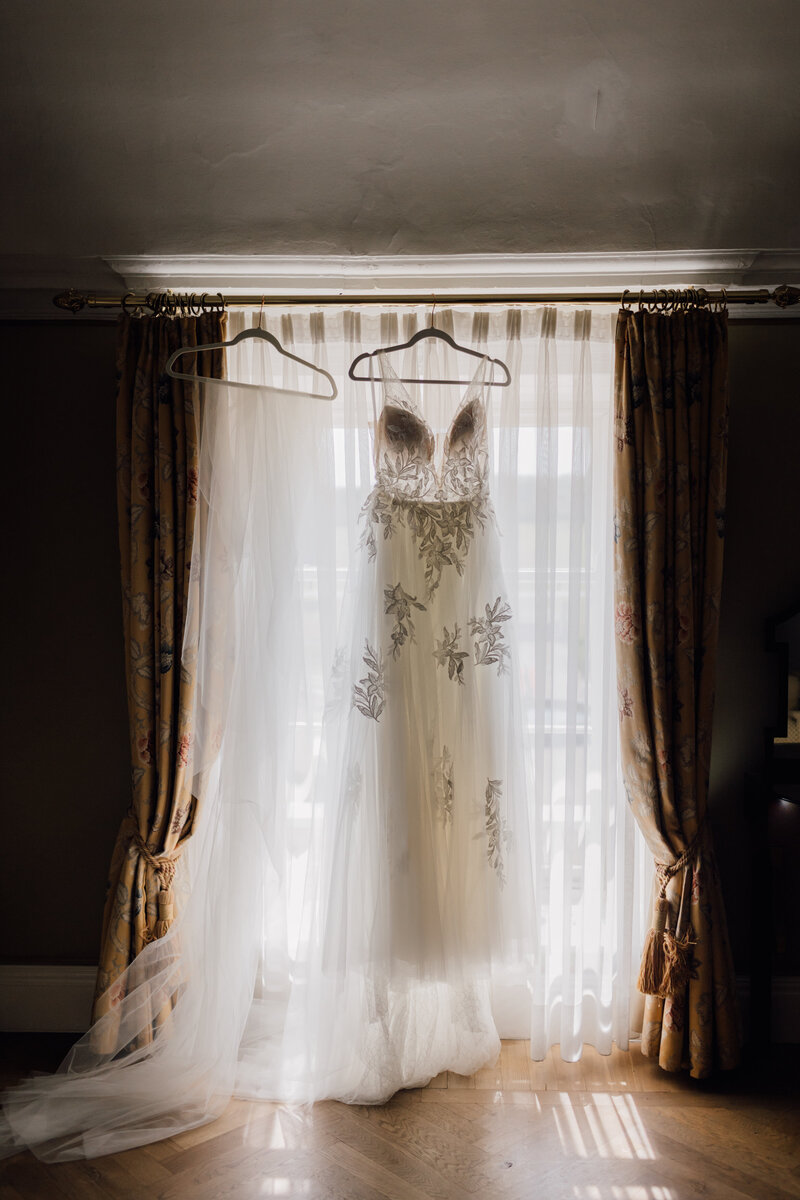 wedding-dress-hanging-in-the-window-of-bridal-suite