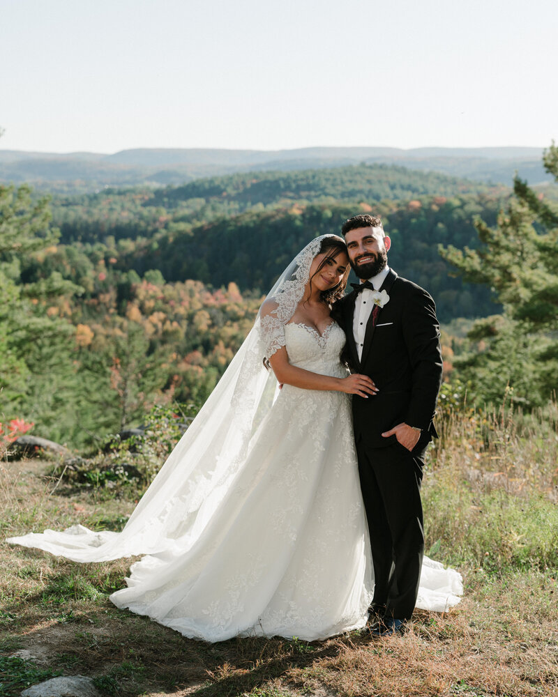 Husband and wife with dog at garden wedding