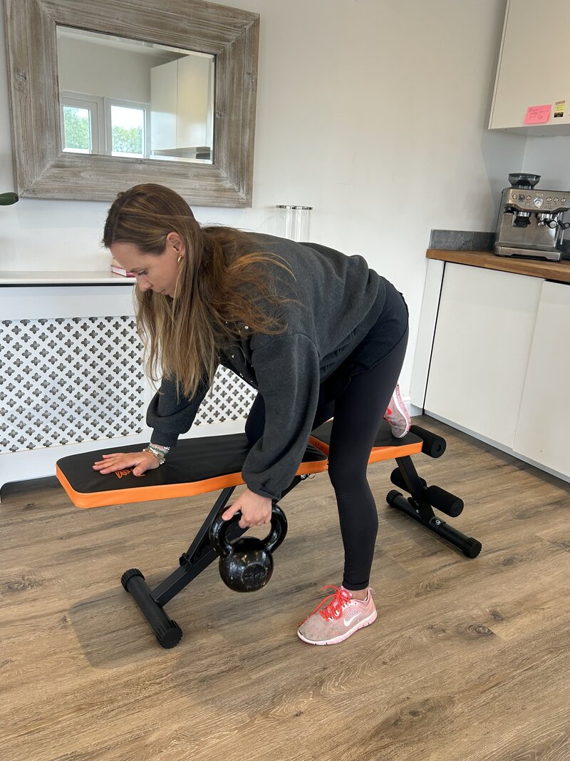 Personal trainer demonstration of a kettlebell row