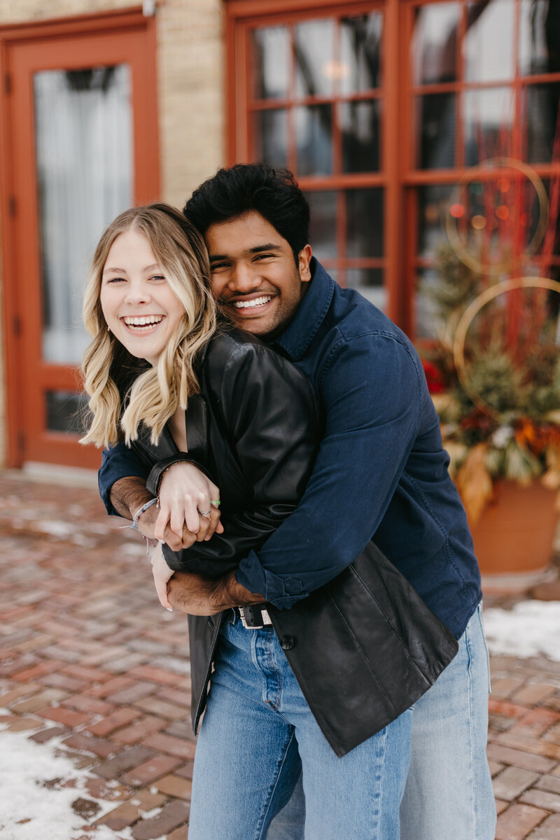 Portrait of a couple with their arms around each other on a street