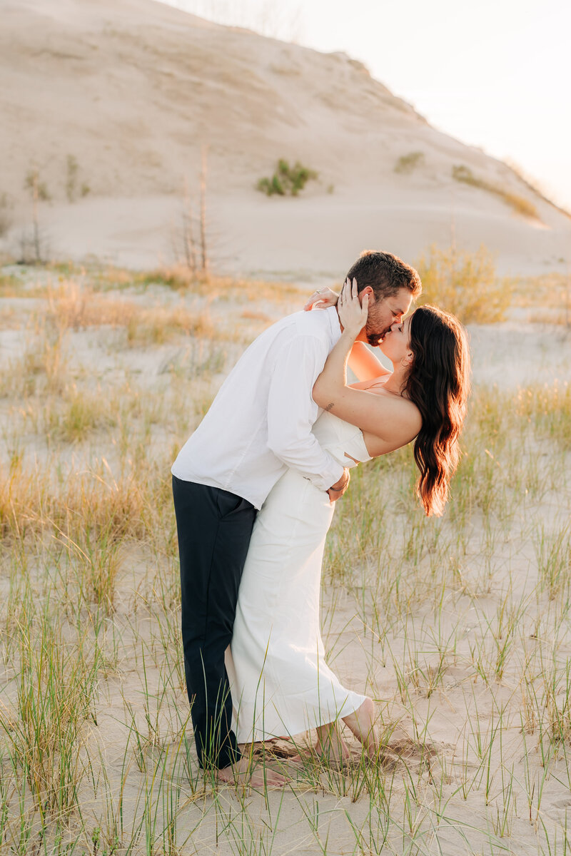 Couple kissing at sunset for engagement photos