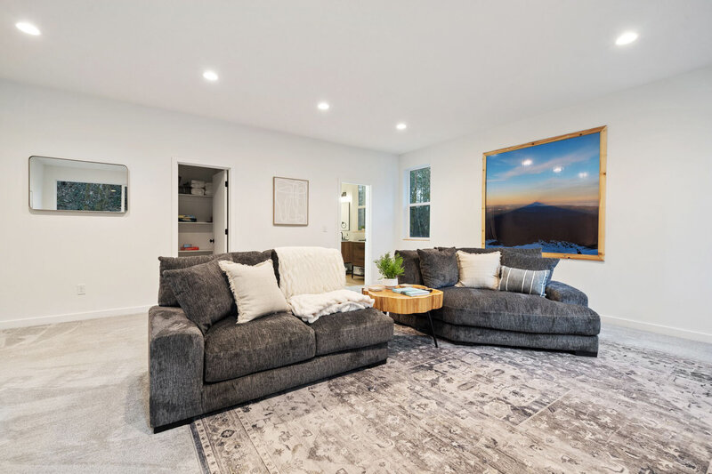 Stylish seating area with plush grey couches and modern decor