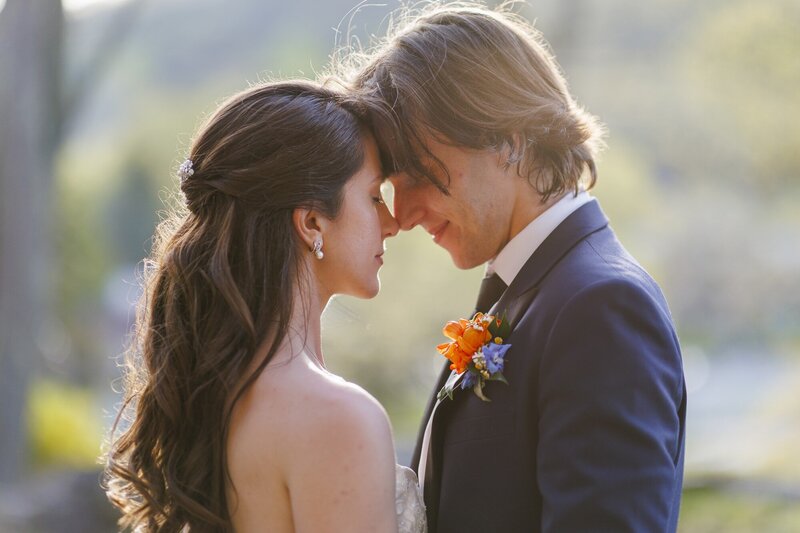 Holly and Nick resting their foreheads together at golden hour on their wedding day