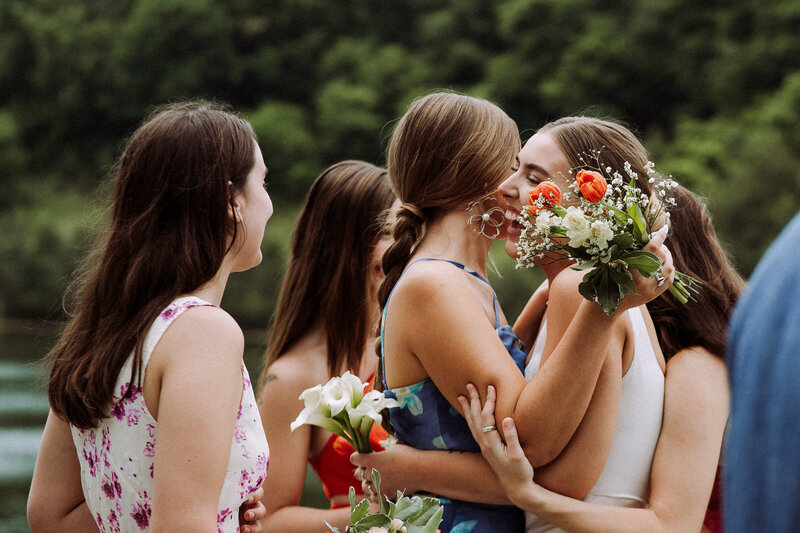 wedding guests embracing bride, holding flowers, celebration