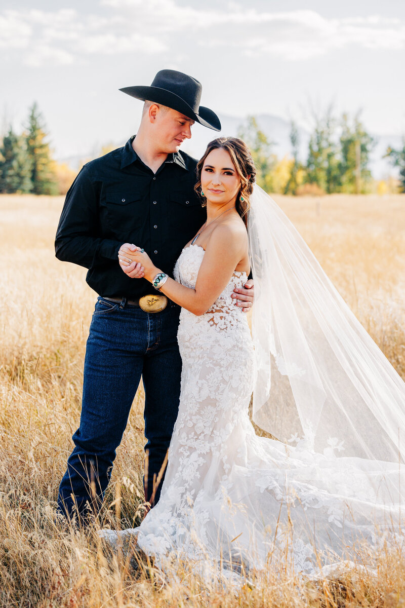 Sunset portrait of bride and groom dancing at Cattle Springs venue in Arlee, MT
