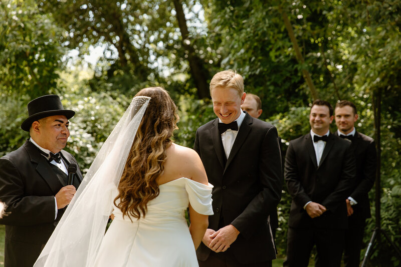 Allie and James' wedding day in Boise, Idaho during their ceremony at Marianne Williams Park captured by Andra Krista Photography